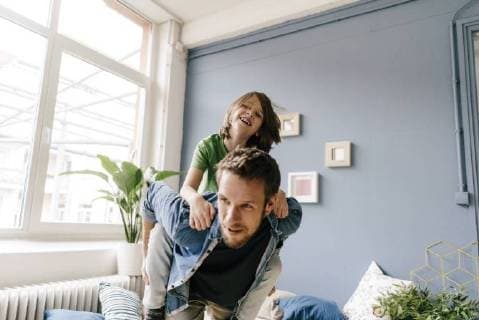 Happy father carrying son piggyback at home model released Symbolfoto property released  KNSF03629