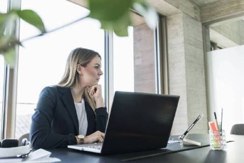 Young businesswoman working with laptop at desk in office model released Symbolfoto property released  UUF13155