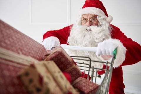 Portrait of Santa claus with shopping cart of Christmas presents model released Symbolfoto  ABIF00110