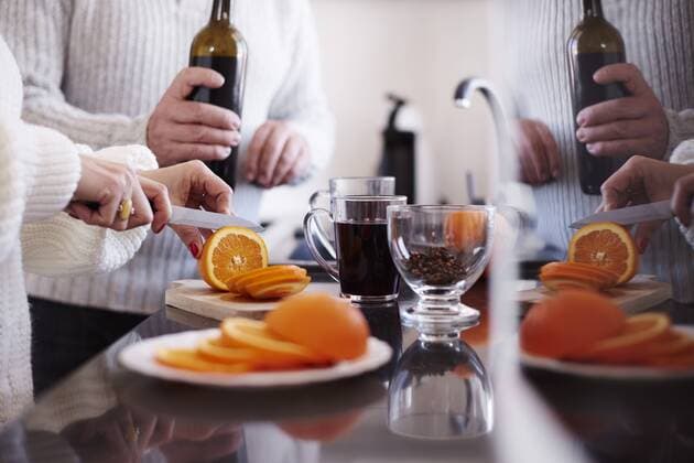 Woman slicing an orange for mulled wine model released Symbolfoto property released  ABIF00199