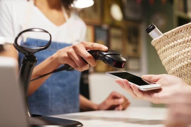 Close-up of customer paying cashless with smartphone at counter of a store model released Symbolfoto property released  EBSF02259