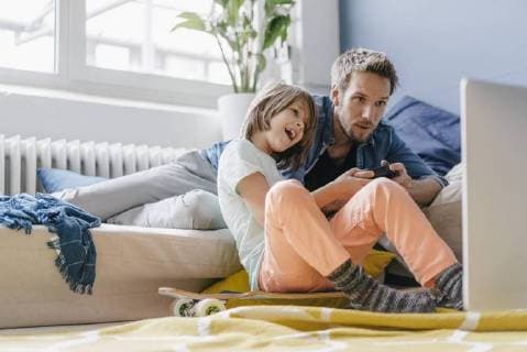 Father and son playing video game together at home model released Symbolfoto property released  KNSF03612
