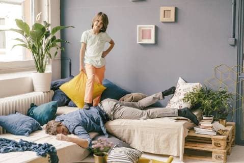 Son defeating father in a pillow fight at home model released Symbolfoto property released  KNSF03618