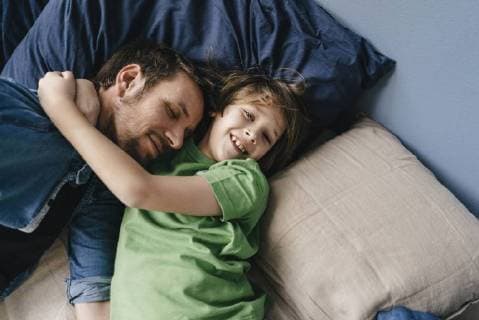 Father and son cuddling at home model released Symbolfoto property released  KNSF03630