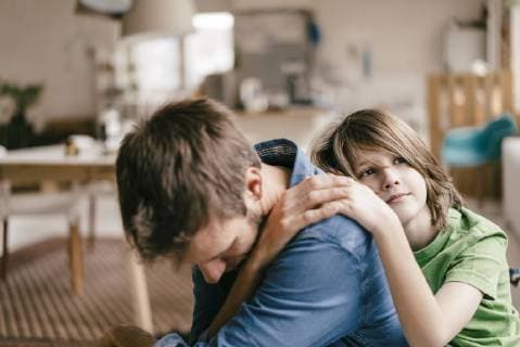 Son consoling sad father at home model released Symbolfoto property released  KNSF03638