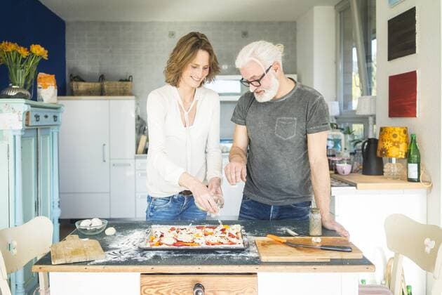 Mature couple preparing a pizza in kitchen at home model released Symbolfoto property released  MOEF00987