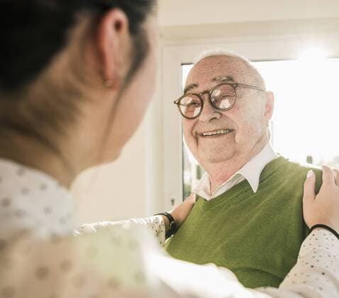 Senior man smiling at young woman model released Symbolfoto property released  UUF12887