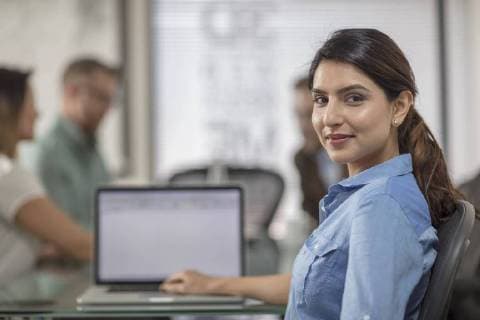 Portrait of smiling businesswoman with laptop during a meeting in office boardroom model released Symbolfoto property released  ZEF15063