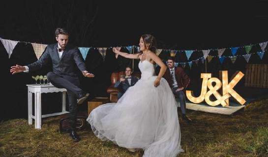 Happy bride and man dancing on a night field party model released Symbolfoto property released  DAPF00937