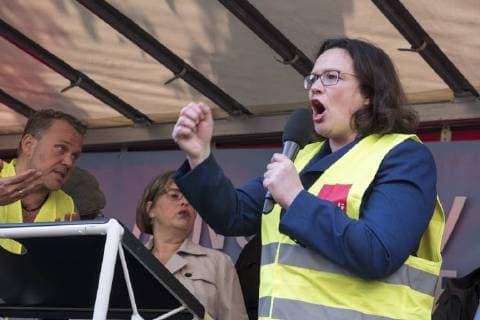 Party leader Andrea Nahles SPD speaks to Amazon employees during a protest action by the United Services Union ver di against the award of the Axel Springer Award to Amazon boss Jeff Bezos in front of Axel Springer Verlag in Berlin Employees protest against the presentation of the Axel Springer Award to Amazon boss Bezos
