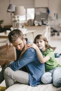 Son consoling sad father at home model released Symbolfoto property released  KNSF03639