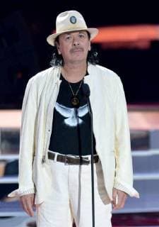 Carlos Santana presents an award onstage during the 2018 Billboard Latin Music Awards at the Mandalay Bay Events Center in Las Vegas, Nevada on April 26, 2018.  LAV20180426325