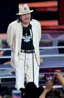 Carlos Santana presents an award onstage during the 2018 Billboard Latin Music Awards at the Mandalay Bay Events Center in Las Vegas, Nevada on April 26, 2018.  LAV20180426328