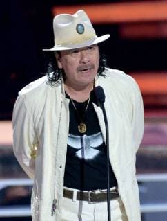 Carlos Santana presents an award onstage during the 2018 Billboard Latin Music Awards at the Mandalay Bay Events Center in Las Vegas, Nevada on April 26, 2018.  LAV20180426330