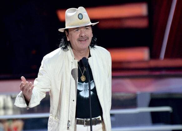 Carlos Santana presents an award onstage during the 2018 Billboard Latin Music Awards at the Mandalay Bay Events Center in Las Vegas, Nevada on April 26, 2018.  LAV20180426331