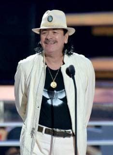 Carlos Santana presents an award onstage during the 2018 Billboard Latin Music Awards at the Mandalay Bay Events Center in Las Vegas, Nevada on April 26, 2018.  LAV20180426332