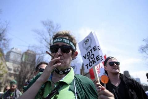 May 5, 2018 - Toronto, Canada - Participant smoking Marijuana during the Toronto Global Marijuana march 2018, just a few months before Canada legalizes Marijuana in Toronto, Canada, on May 5, 2018. Toronto Canada  - ZUMAn230 20180505_zaa_n230_1297 Copyright: xArindamxShivaanix