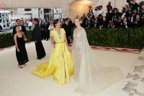 Lily Aldridge and Rosie Huntington-Whiteley arrive on the red carpet at The Metropolitan Museum of Art s Costume Institute Benefit Heavenly Bodies: Fashion and the Catholic Imagination at Metropolitan Museum of Art in New York City on May 7, 2018.  NYP20180507355 JOHNxANGELILLO