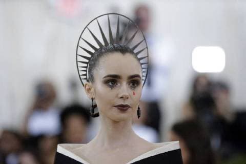 Lily Collins arrives on the red carpet at The Metropolitan Museum of Art s Costume Institute Benefit Heavenly Bodies: Fashion and the Catholic Imagination at Metropolitan Museum of Art in New York City on May 7, 2018.  NYP20180507828 JOHNxANGELILLO