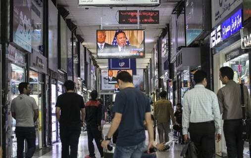(180508) -- TEHRAN, May 8, 2018 -- People follow the news on a TV at a shop center in central Tehran, capital of Iran, on May 8, 2018. Iranians across the country are awaiting for the critical time when U.S. President Dunald Trump will announce his decision on the Iran nuclear agreement Tuesday at White House. ) (rh) IRAN-TEHRAN-LIFE-NUCLEAR DEAL AhmadxHalabisaz 