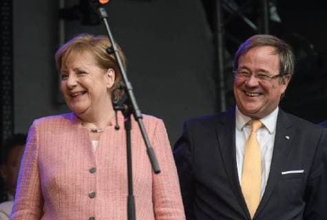 Presentation of the Charlemagne Prize 2018 to Emmanuel Macron The picture shows the German Chancellor Angela Merkel with the Prime Minister of the German Federal State North Rhine Westphalia Armin Laschet 2018 Presentation of the Charlemagne Prize 2018 to Emmanuel Macron