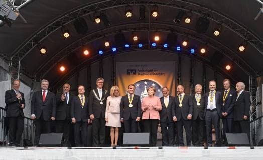 Presentation of the Charlemagne Prize 2018 to Emmanuel Macron Picture from left to right Press Secretary Aachen Bernd Büttgens President of Ukraine Petro Poroshenko NN Javier Solana Lord Mayor of Aachen Marcel Philip Brigitte Macron President of France Emmanuel Macron Chancellor Angela Merkel Prime Mi
