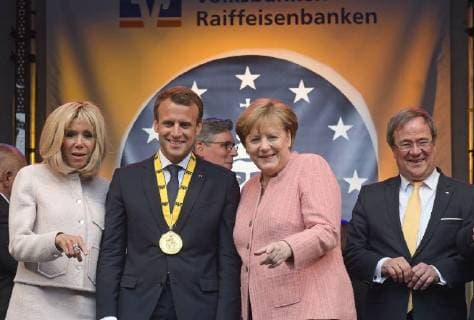 Presentation of the Charlemagne Prize 2018 to Emmanuel Macron The picture shows French President Emmanuel Macron with Karl Medal alongside German Chancellor Angela Merkel and Prime Minister of the German Federal State of North Rhine Westphalia Armin Laschet 2018 Awarding of the Karlspreis 2018 to Emmanuel Macron