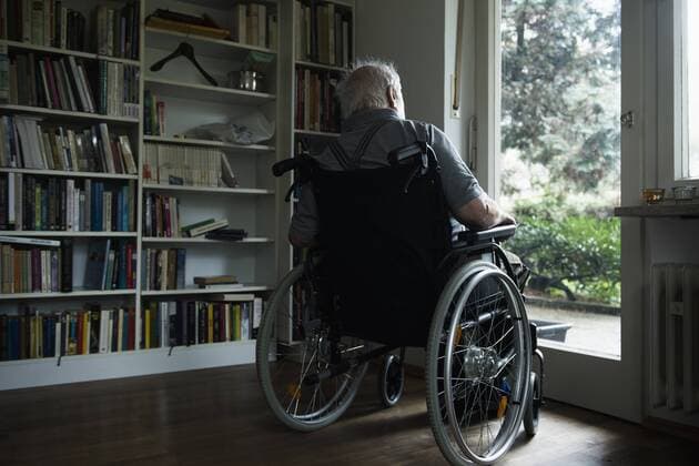 Senior man in wheelchair looking out through window, Altoetting, Bavaria, Germany, Europe mit_2032_11231