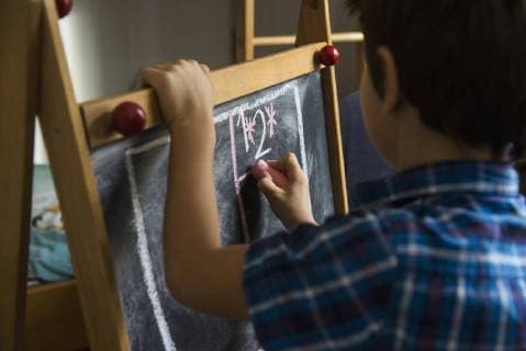Close-up of a boy writing on a blackboard, Munich, Germany mit_2032_11445