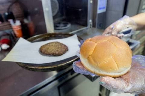 MOSCOW, RUSSIA â€“ MAY 17, 2018: Making a burger with a football bun at a Gazprom Neft filling station. Sergei Bobylev TASS  TS0801D7