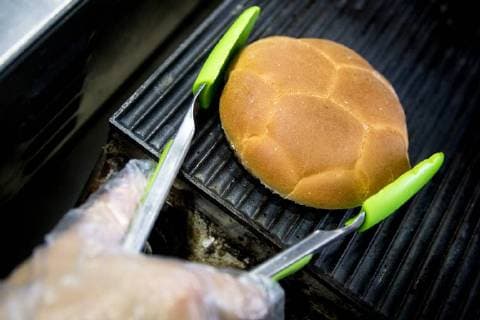 MOSCOW, RUSSIA â€“ MAY 17, 2018: Making a burger with a football bun at a Gazprom Neft filling station. Sergei Bobylev TASS  TS0801DA