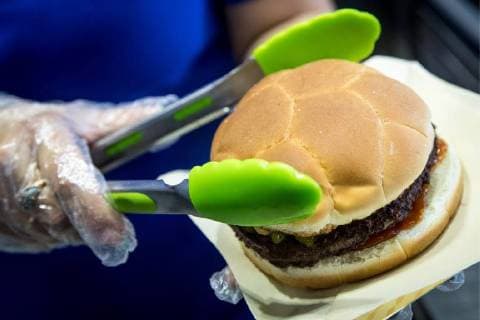 MOSCOW, RUSSIA â€“ MAY 17, 2018: Making a burger with a football bun at a Gazprom Neft filling station. Sergei Bobylev TASS  TS0801DB