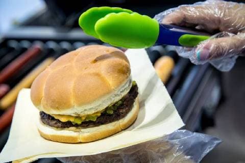 MOSCOW, RUSSIA â€“ MAY 17, 2018: Making a burger with a football bun at a Gazprom Neft filling station. Sergei Bobylev TASS  TS0801E3