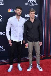 Recording artists Alex Pall (L) and Andrew Taggart of musical group The Chainsmokers arrive for the 2018 Billboard Music Awards at MGM Grand Garden Arena on May 20, 2018 in Las Vegas, Nevada.  LAV20180520225 JIMxRUYMEN