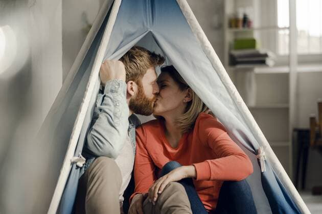 Happy couple at home camping ina tent in the livingroom model released Symbolfoto property released  KNSF03736