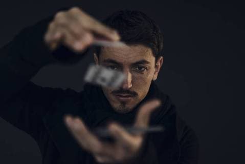 Portrait of magician conjuring with playing cards model released Symbolfoto property released  KNSF03789