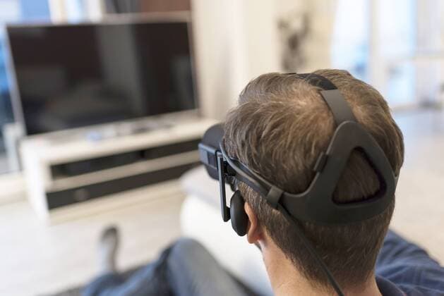Man wearing VR glasses watching Tv model released Symbolfoto property released  PAF01818