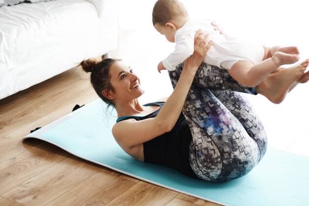 Mother and baby exercising on yoga mat at home model released Symbolfoto property released  ABIF00336