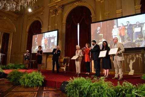 (C) Queen Paola of Belgium, Princess Claire of Belgium and German Community Minister of Education, Formation and Scientific Research Harald Mollers pose with laureates during a ceremony for the Queen Paola Award 2017-2018 (Koningin Paolaprijs - Prix Reine Paola) for education, at the royal castle in Laken Laeken, Brussels, Wednesday 30 May 2018.  CAMILLExDELANNOIS 05356505