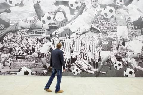 MOSCOW, RUSSIA - JUNE 1, 2018: A man views an exhibition on the 1897-2018 history of Russian football at the VDNKh exhibition centre. The exhibition covers the history of Russian and Soviet football from the first football team in the Russian Empire (1897) up to the present times. Alexander Shcherbak TASS  TS0822C5