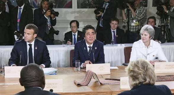 G-7 summit in Canada (From L) French President Emmanuel Macron, Japanese Prime Minister Shinzo Abe and British Prime Minister Theresa May attend a meeting at the Group of Seven summit in Charlevoix, Canada, on June 9, 2018. 