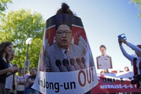 June 9, 2018 - Quebec City, Ontario, Canada - Anti Justin Trudeau and anti Kim Jong-un supporters with cut out and banners during a rally to protest the G7 summit in Quebec City, Canada on 9 June 2018. During the last day of the G7 summit that is happening in La Malbaie, Quebec, protesters came on to the streets to protest the summit in Quebec City. Quebec City Canada  - ZUMAn230 20180609_zaa_n230_1054 Copyright: xArindamxShivaanix