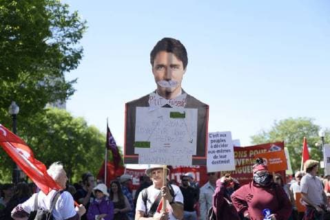 June 9, 2018 - Quebec City, Ontario, Canada - Protesters with a cut out of Justin Trudeau during a rally to protest the G7 summit in Quebec City, Canada on 9 June 2018. During the last day of the G7 summit that is happening in La Malbaie, Quebec, protesters came on to the streets to protest the summit in Quebec City. Quebec City Canada  - ZUMAn230 20180609_zaa_n230_1055 Copyright: xArindamxShivaanix