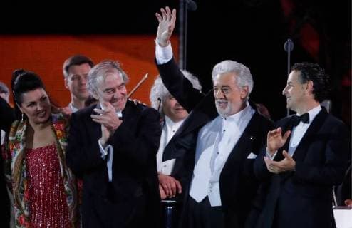 MOSCOW, RUSSIA â€“ JUNE 13, 2018: Russian soprano Anna Netrebko, Mariinsky Theatre artistic director, conductor Valery Gergiev, Spanish tenor Placido Domingo, and Peruvian tenor Juan Diego Florez (L-R front) acknowledge the audience after a concert by opera stars ahead of the 2018 FIFA World Cup, at Moscow s Red Square. Mikhail Metzel TASS  TS083FEB