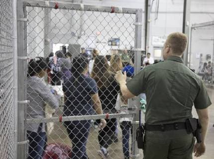 June 18, 2018 - McAllen, Texas, U.S. - In this photo provided by on, a U.S. Border Patrol agent watches as people who ve been taken into custody related to cases of illegal entry into the United States, stand in line at a facility in McAllen, Texas, Sunday, June 17, 2018. McAllen U.S.  - ZUMA 20180618_jlr_z03_007 Copyright: xU.S.xCustomsxandxBorderxProtectix