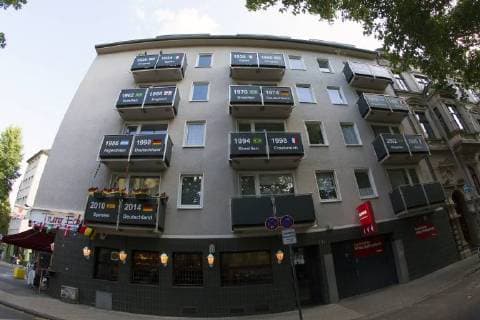 The balconies of a house are decorated with all previous world champions during the Football World Cup 2018 Huge Germany flag