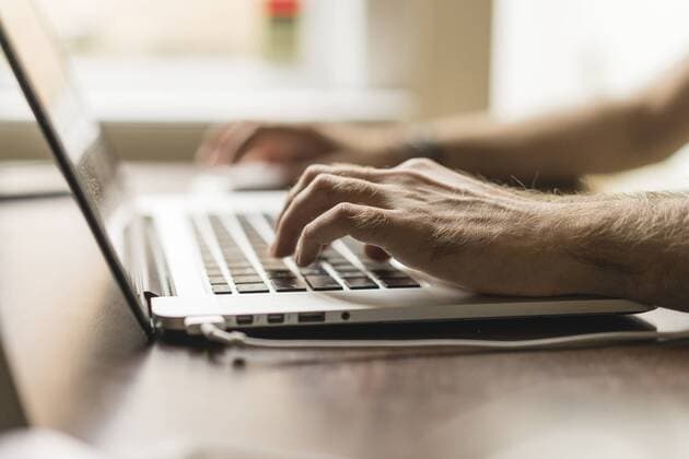 Man s hand on keyboard of laptop, partial view model released Symbolfoto  AFVF00496