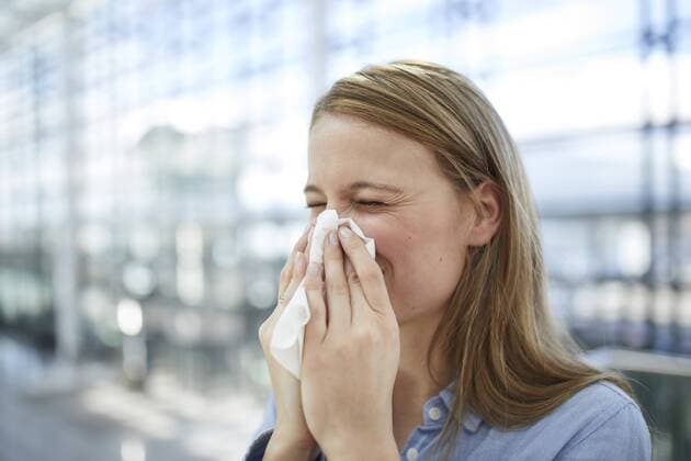 Young woman blowing nose model released Symbolfoto  PNEF00612