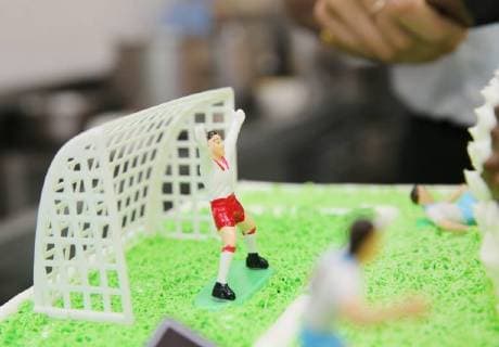 China: Football shaped cake Bakers make a World Cup themed cake at a bakery in Nantong, east China s Jiangsu Province. People can see football and football field at the cake. CHINA OUT Nantong Nantong China  XuxCongjun