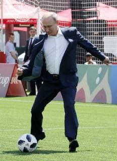 MOSCOW, RUSSIA - JUNE 28, 2018: Russia s President Vladimir Putin kicks the ball as he visits the 2018 FIFA World Cup Football Park in Red Square. Mikhail Metzel TASS  TS086D61